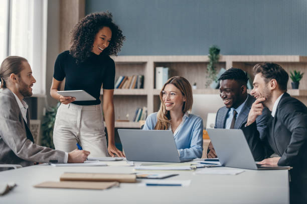 Diverse team of professionals smiling and working together in an office.